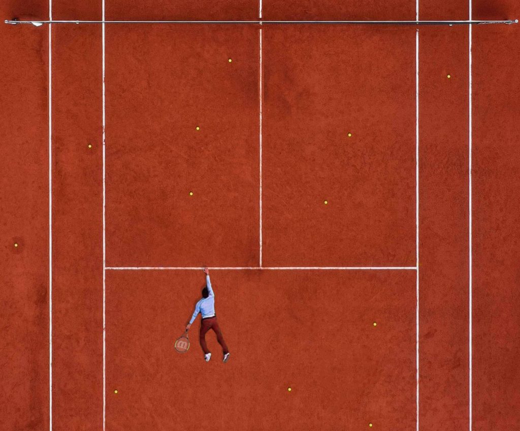 Man laying down on tennis court