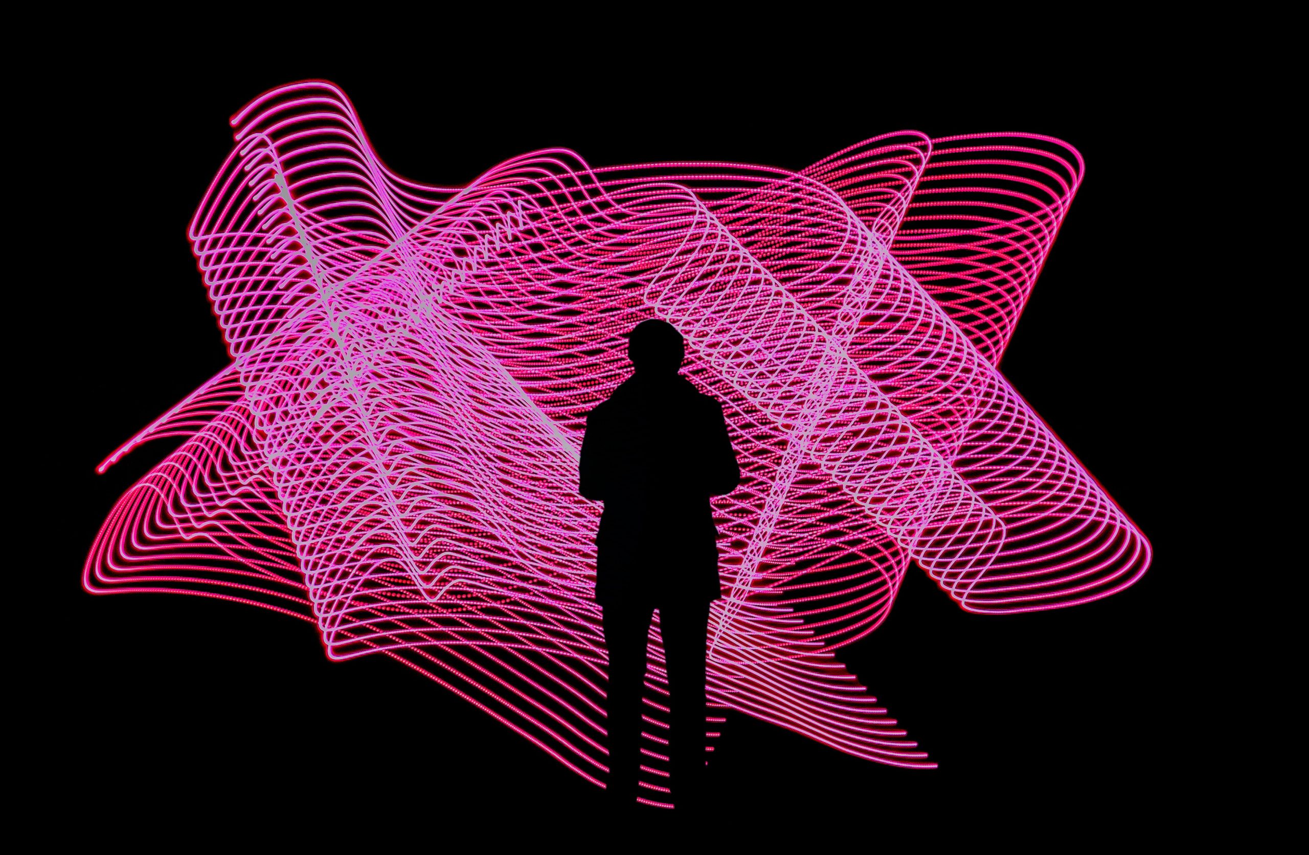 Man standing in front of pink graphic